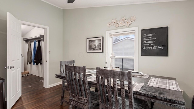 dining space with dark wood-type flooring, ornamental molding, and baseboards