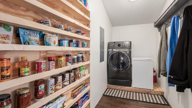 washroom featuring laundry area, a textured ceiling, and wood finished floors