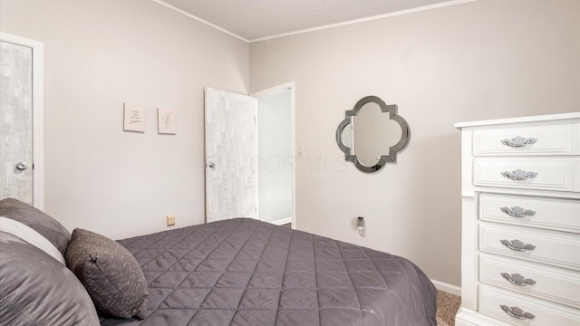 bedroom featuring baseboards and crown molding