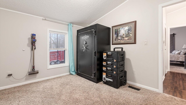 interior space featuring a textured ceiling, ornamental molding, visible vents, and baseboards