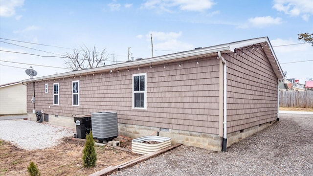 view of side of property with crawl space and cooling unit