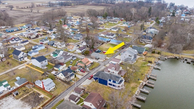 birds eye view of property featuring a water view and a residential view