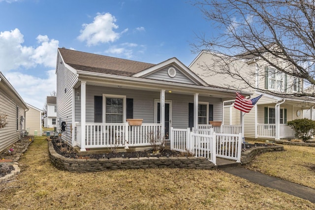 view of front of property with a porch and roof with shingles