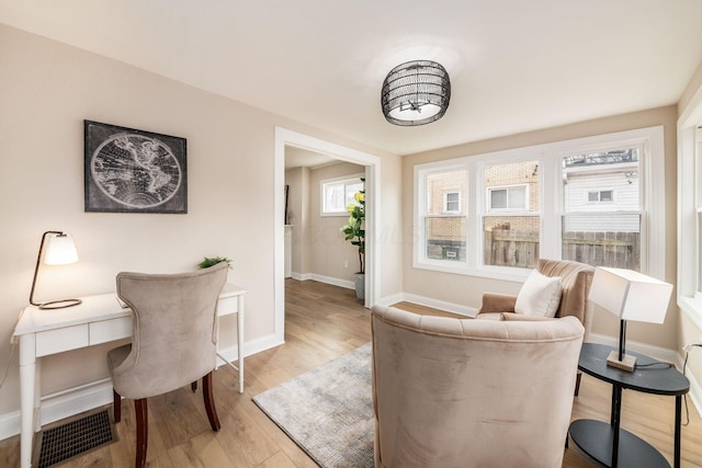 office with baseboards and light wood-style floors