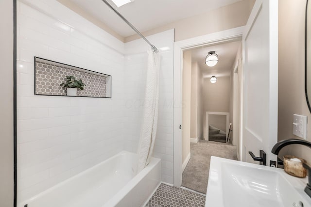 full bath featuring shower / bath combo with shower curtain and a sink