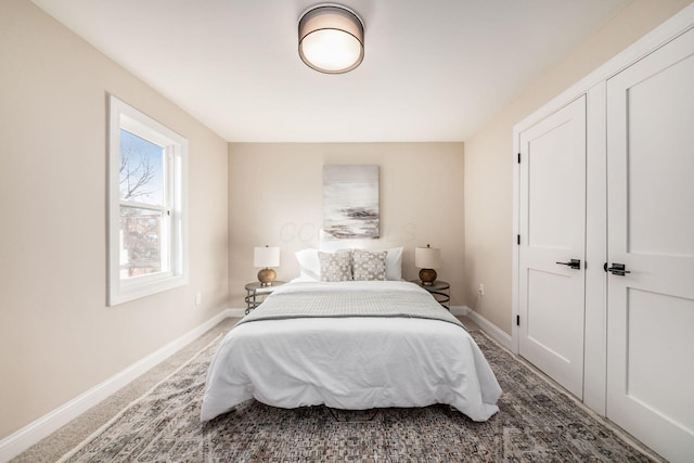 carpeted bedroom featuring baseboards