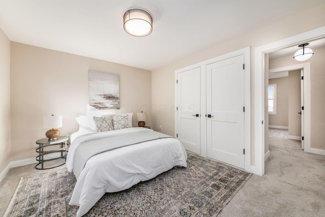 bedroom with carpet floors, a closet, and baseboards