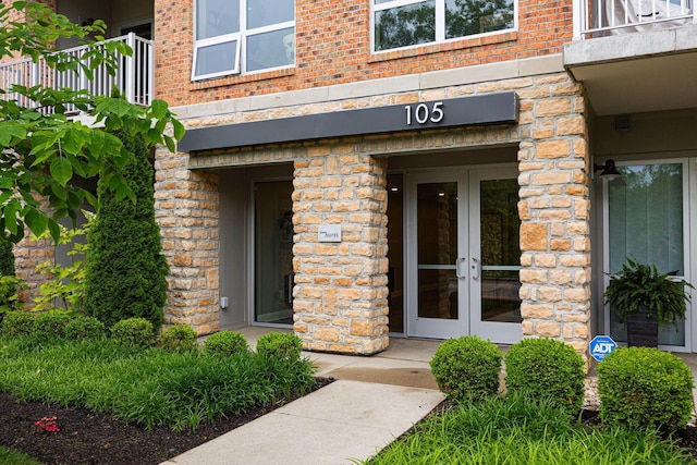 105 N Riverview St Unit 216, Dublin, OH 43017 - property entrance with french doors, a balcony, brick siding, and stone siding