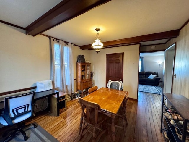 dining area with beamed ceiling and hardwood / wood-style flooring