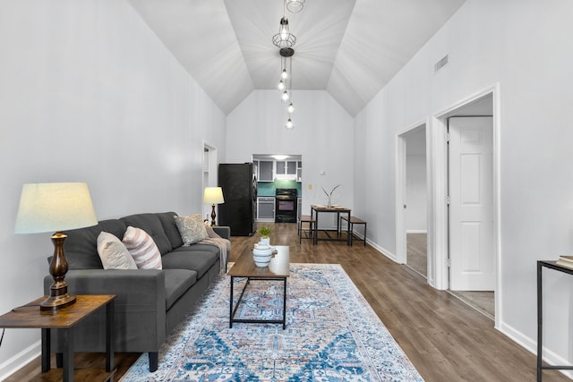 143 Walnut St, Sunbury, OH 43074 - living area with high vaulted ceiling, wood finished floors, and baseboards
