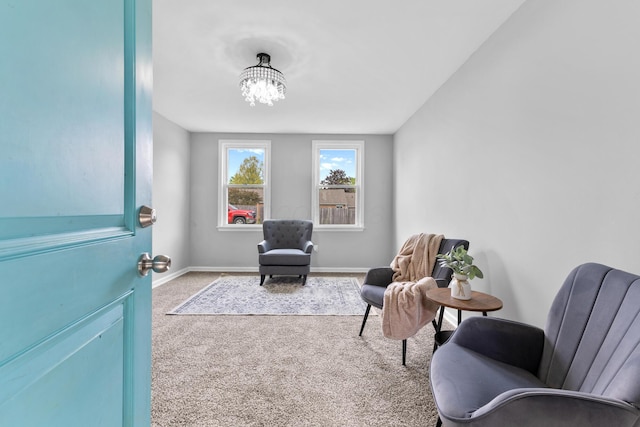143 Walnut St, Sunbury, OH 43074 - living area with carpet flooring, baseboards, and a chandelier