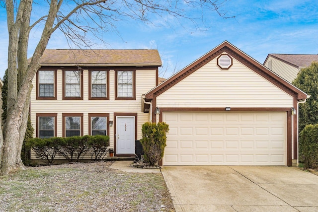 colonial home with concrete driveway and an attached garage