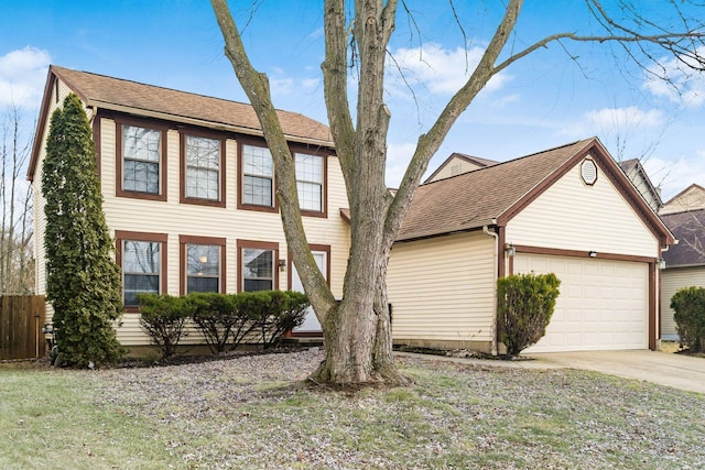 colonial-style house with a garage, driveway, a shingled roof, and fence