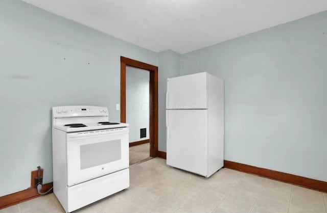 kitchen with white appliances and baseboards