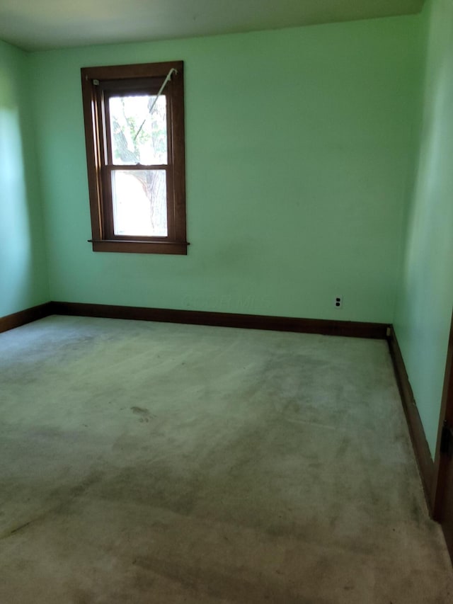 empty room with carpet flooring and baseboards