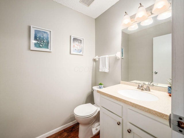 5610 Barney Ln Unit 41F, Columbus, OH 43235 - half bath featuring toilet, vanity, wood finished floors, and baseboards