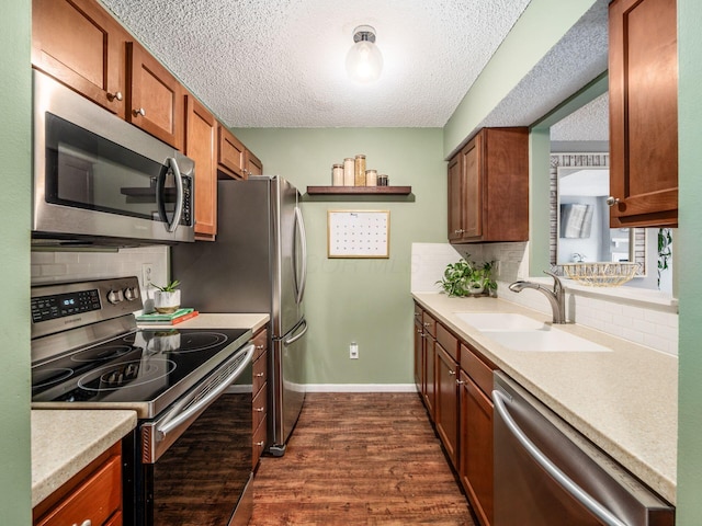 5610 Barney Ln Unit 41F, Columbus, OH 43235 - kitchen featuring stainless steel appliances, a sink, dark wood-style flooring, backsplash, and light countertops