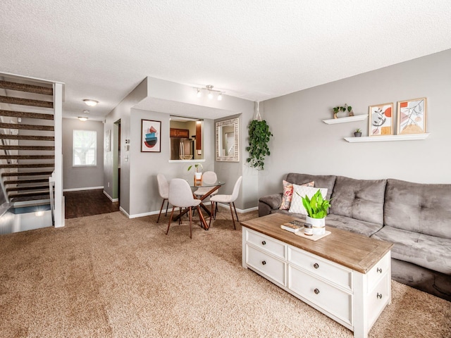 5610 Barney Ln Unit 41F, Columbus, OH 43235 - living room featuring light carpet, a textured ceiling, and baseboards