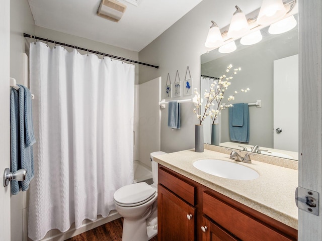 5610 Barney Ln Unit 41F, Columbus, OH 43235 - bathroom with toilet, vanity, shower / tub combo with curtain, and wood finished floors