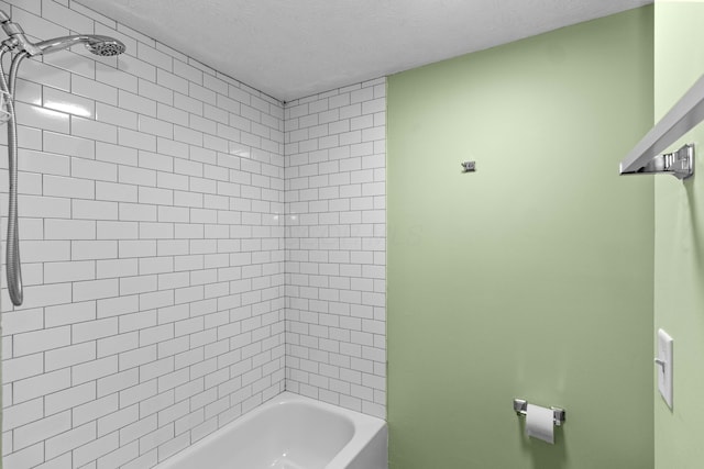 bathroom featuring shower / washtub combination and a textured ceiling