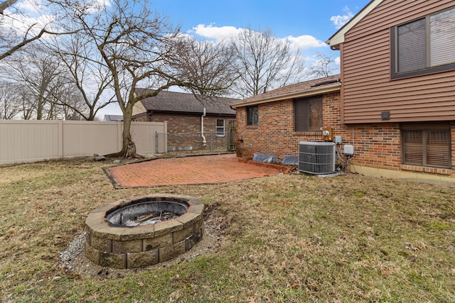 view of yard featuring a fire pit, a patio, central AC unit, and fence