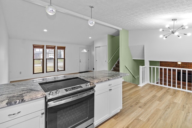 kitchen with lofted ceiling with beams, a textured ceiling, white cabinets, electric stove, and light wood-type flooring