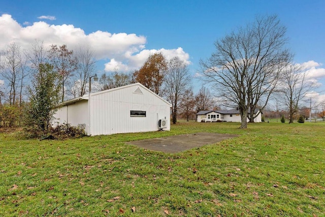 exterior space featuring an outbuilding, a pole building, and a lawn