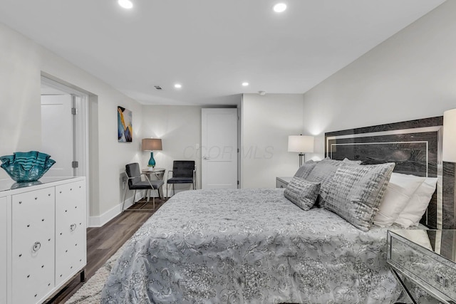 bedroom featuring baseboards, wood finished floors, visible vents, and recessed lighting