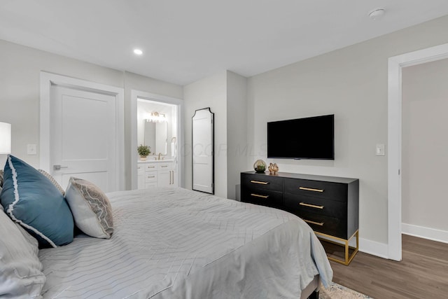 bedroom featuring recessed lighting, connected bathroom, baseboards, and wood finished floors