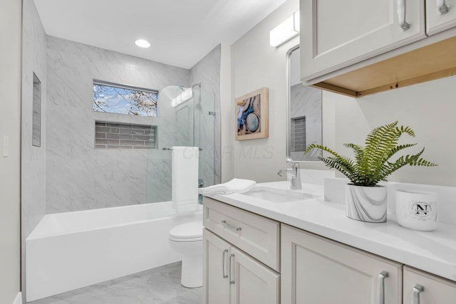 full bathroom featuring marble finish floor, recessed lighting, shower / bath combination, toilet, and vanity