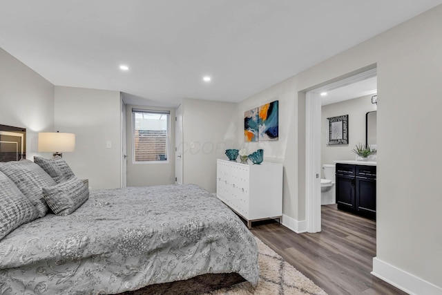 bedroom featuring recessed lighting, connected bathroom, baseboards, and wood finished floors