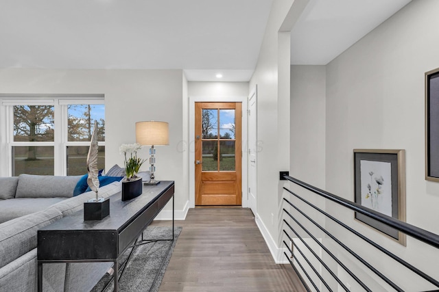 interior space with plenty of natural light, baseboards, wood finished floors, and recessed lighting