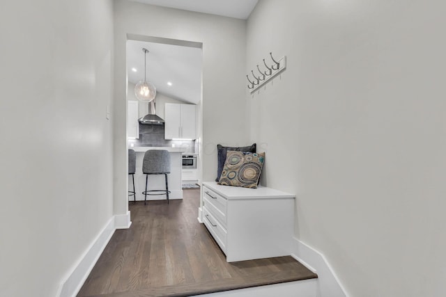 hallway featuring baseboards, dark wood-type flooring, and recessed lighting