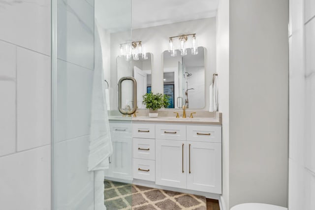 bathroom featuring a shower and vanity