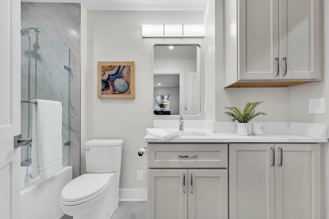 bathroom with toilet, bath / shower combo with glass door, vanity, baseboards, and marble finish floor