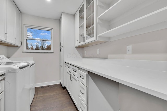 laundry room with dark wood-style floors, cabinet space, independent washer and dryer, and baseboards