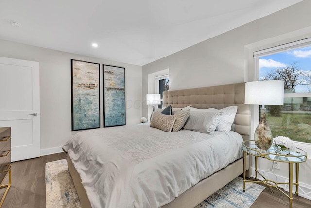 bedroom with baseboards, wood finished floors, and recessed lighting