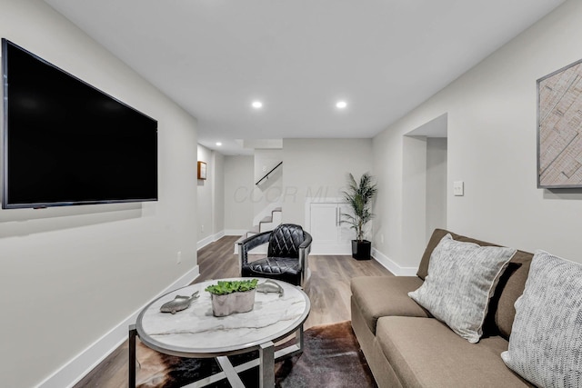 living room with baseboards, stairway, wood finished floors, and recessed lighting