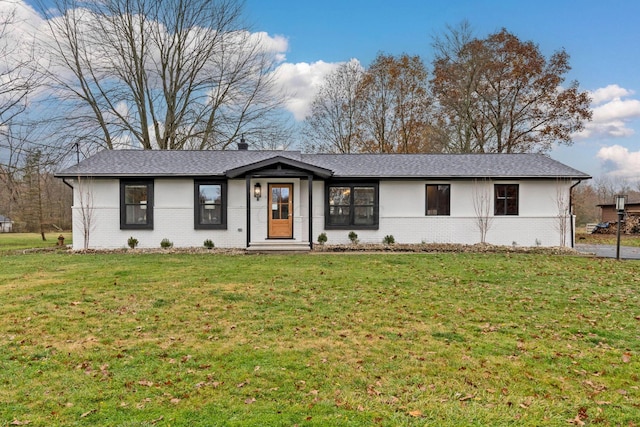 ranch-style house featuring brick siding and a front yard