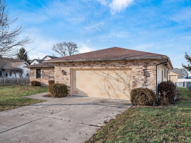 view of side of home featuring a garage, brick siding, a shingled roof, fence, and concrete driveway