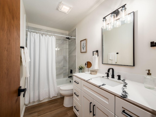 full bathroom with vanity, wood finished floors, toilet, and shower / tub combo with curtain