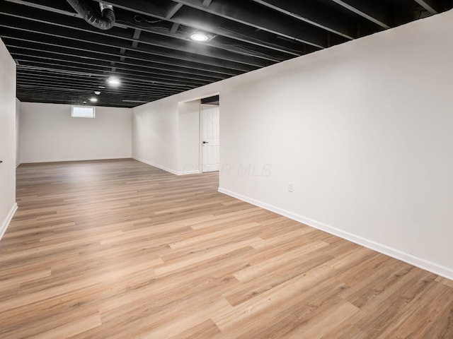 basement with wood finished floors and baseboards