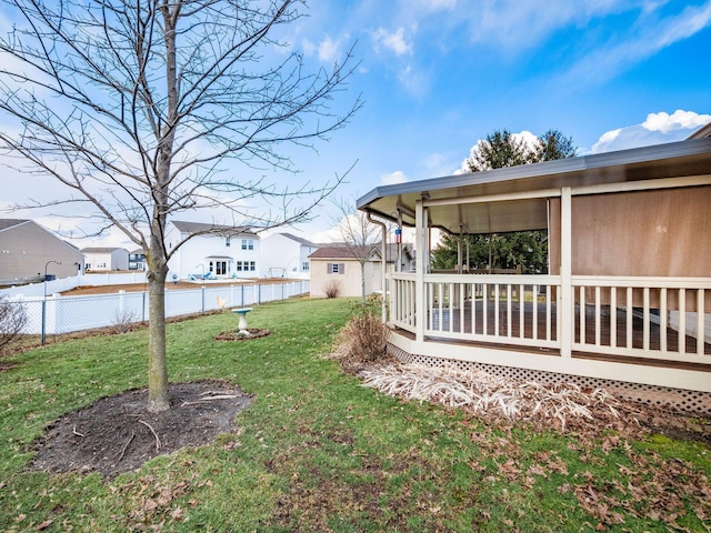 view of yard with an outbuilding, a residential view, fence, and a wooden deck