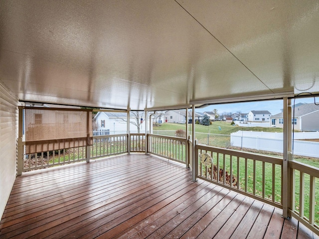 wooden deck with a yard, fence, and a residential view