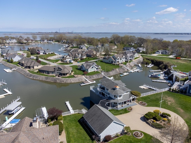 drone / aerial view with a residential view and a water view