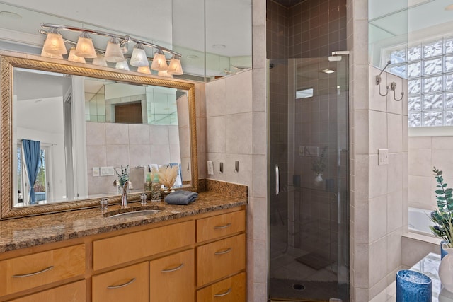 full bath with decorative backsplash, a stall shower, tile walls, and vanity