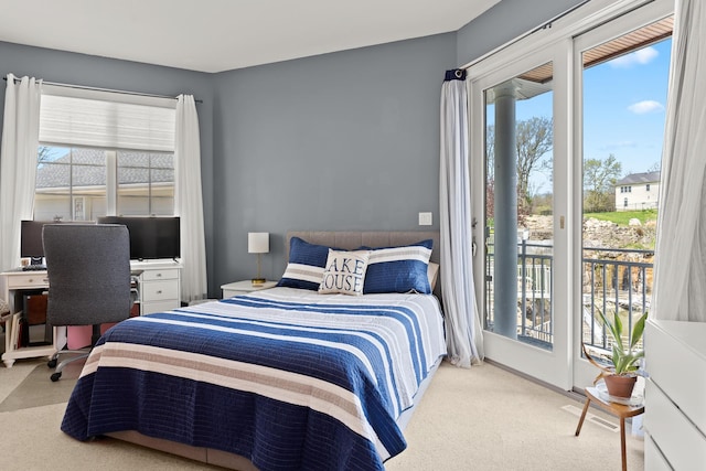 carpeted bedroom featuring access to exterior and multiple windows