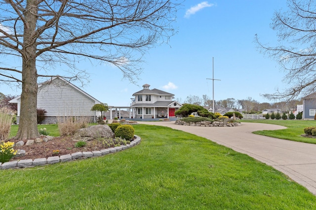 view of front of home featuring concrete driveway and a front yard