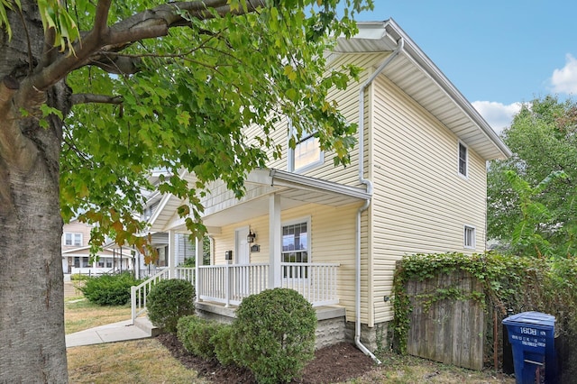 exterior space featuring fence and a porch