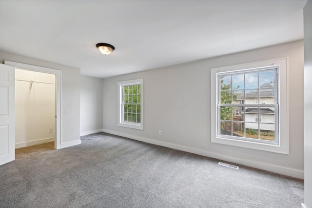 interior space featuring carpet floors, visible vents, and baseboards